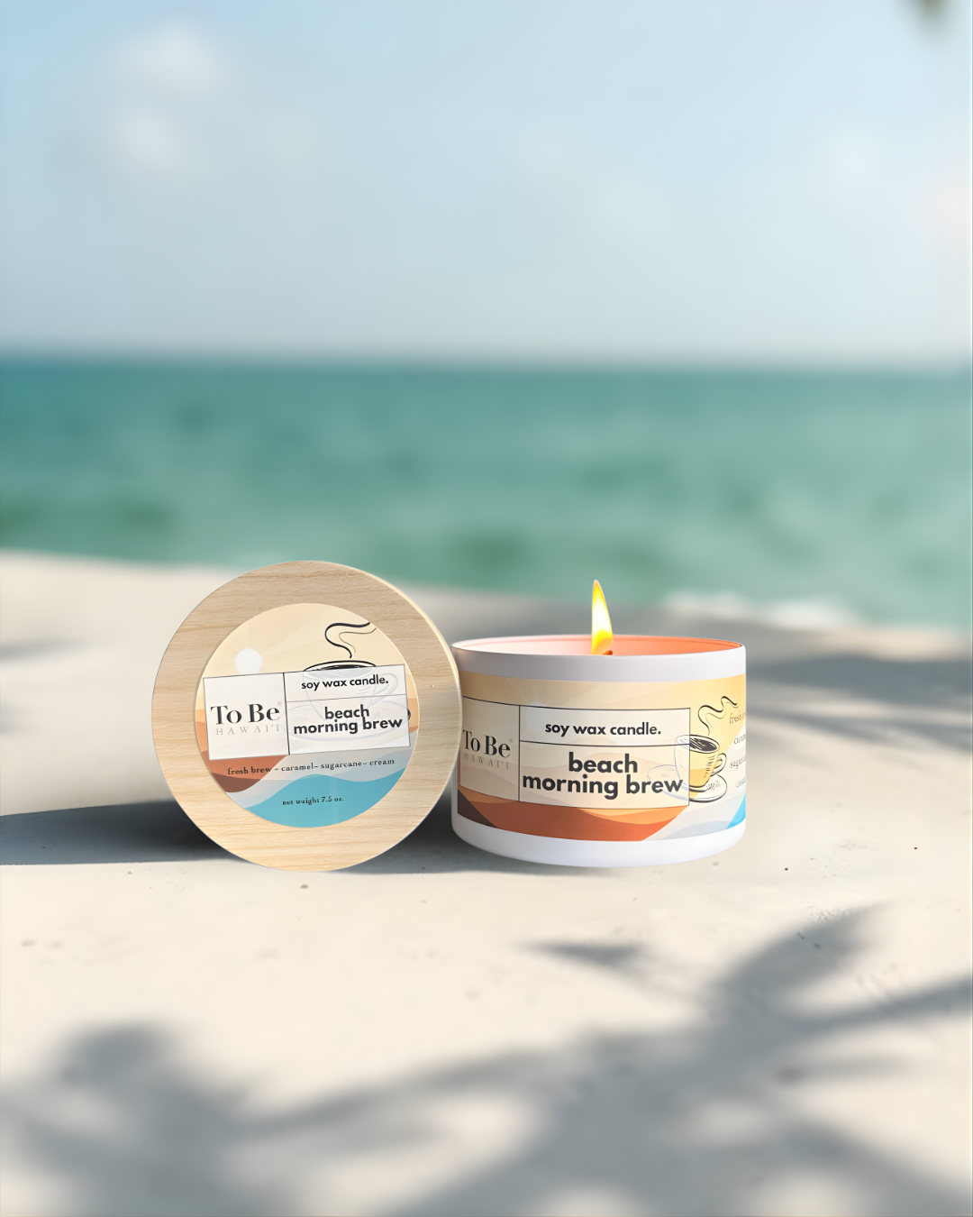 Candle labeled 'Beach Morning Brew' on sand with ocean background